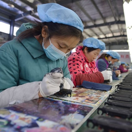 An employee works on an assembly line producing speakers at a factory in Fuyang, Anhui province, eastern China, on November 30. Global demand for Chinese products should drive economic recovery as China reopens, and there is also the prospect of greater lift from revived domestic consumer demand. Photo: AFP