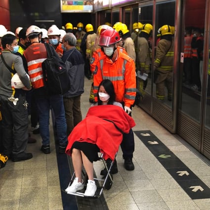 A woman is evacuated from Tseung Kwan O MTR station after a train stopped in the middle of the tracks. Photo: Elson Li