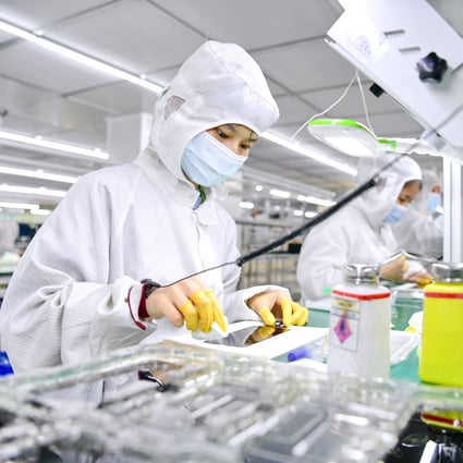 Employees work on a production line for 5G smartphone screens on May 13 in Ganzhou, Jiangxi province, China. Photo: Getty Images