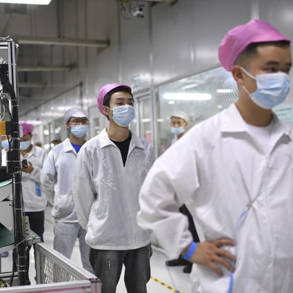Workers queue up to get tested for Covid-19 at the Foxconn factory in Wuhan, Hubei province, on August 5, 2021. Labour shortages and demonstrations at the Foxconn factory in Zhengzhou have renewed concerns over China’s increasingly precarious place in the global supply chain. Photo: AP
