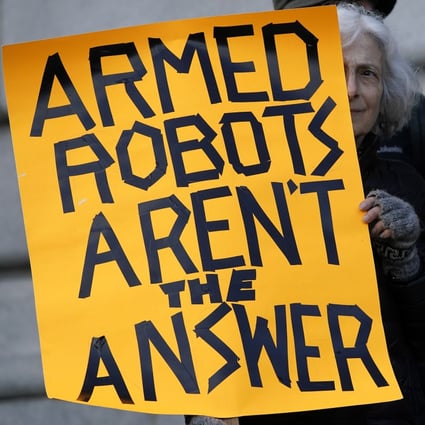 A protester in San Francisco holds up a sign while demonstrating on Monday against the use of “killer robots” by police. Photo: AP