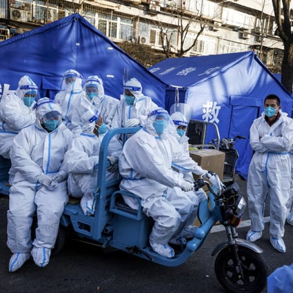 Pandemic prevention workers head for buildings where residents are under home quarantine in Beijing. Photo: Reuters