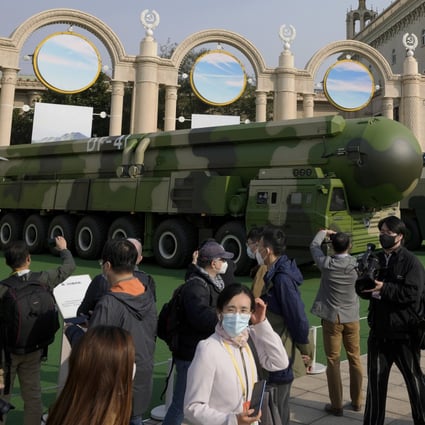 Visitors look at Chinese military vehicles carrying Dongfeng-41 and Dongfeng-17 ballistic missiles at the Beijing Exhibition Centre in October. Photo: AP