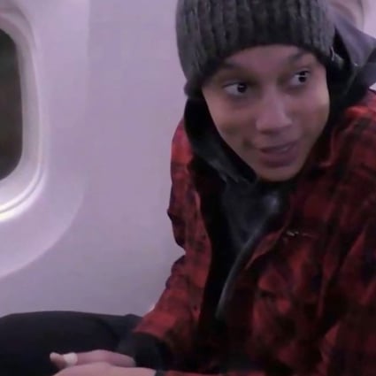 A video grab taken from Russian state media footage shows Brittney Griner sitting on a plane after being released from prison in Moscow. Photo via AFP
