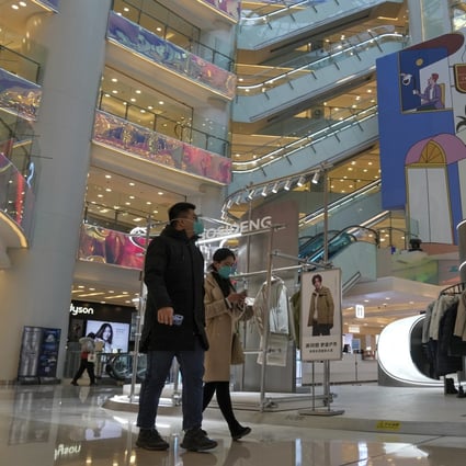 Shoppers in a Beijing shopping mall after the capital started to ease its restrictions. Photo: AP
