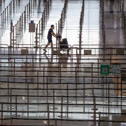 A traveller walks through the arrivals hall at Hong Kong International Airport on August 8. The aviation industry in Asia is unlikely to recover to 2019 levels before 2025. Photo: Bloomberg