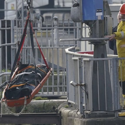 UK emergency staff remove a stretcher holding a body bag from a lifeboat after it returned to Dover following a search and rescue operation in the Channel off the coast of Kent on Wednesday. Photo: via AP