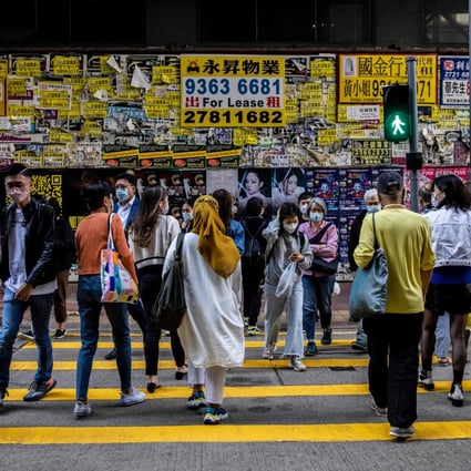 Pedestrians cross a road in Hong Kong on December 9. It is time for Hong Kong to fully embrace multilingualism. Photo: AFP 