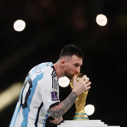 Argentina’s Lionel Messi kisses the World Cup trophy during the trophy ceremony. Photo: Reuters