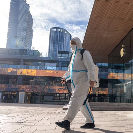 Health workers disinfect a deserted shopping mall in Beijing on December 15. Photo: AP