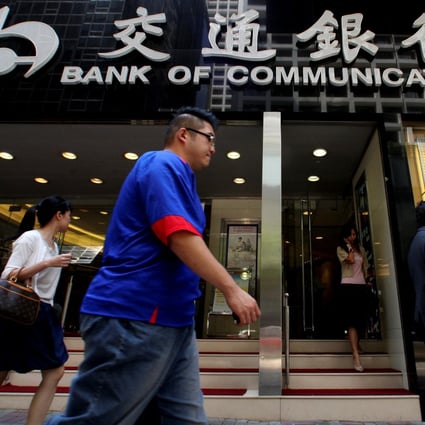 People walk past the Bank of Communications outlet in Ccentra, Hong Kong. Photo: Reuters