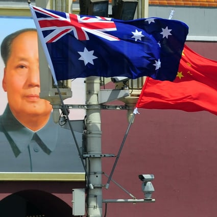 The national flags of Australia and China are displayed before a portrait of Mao Zedong facing Tiananmen Square, during a visit by Australia’s Prime Minister Julia Gillard in Beijing on April 26, 2011. Photo: AFP via Getty Images