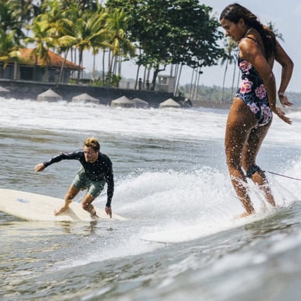 Dropping in, or stealing someone else’s wave, is among the worst breaches of surfing etiquette there is, and in the breaks off Medewi, Bali, it has become more common with the growth in foreign tourists surfing there. Here, a woman surfer drops in on another surfer riding a wave. Photo: Instagram/@onedayasurfer