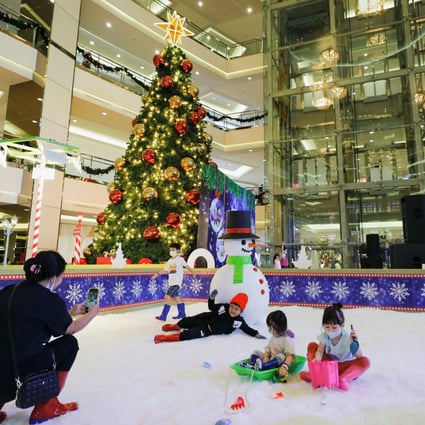 Children play in artificial snow near a Christmas tree at a Jakarta shopping centre this month. A resident of Surabaya said she believed it was “wrong” for Muslims to take selfies near Christmas trees. Photo: Reuters