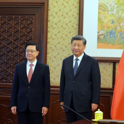 Hong Kong Chief Executive John Lee with President Xi Jinping. Photo: Pool