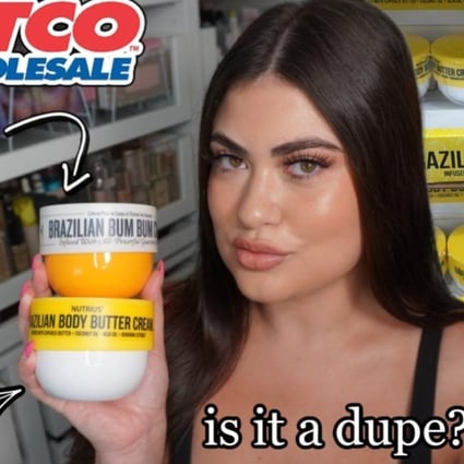 A content creator holding a cheaper version of Sol Janeiro Brazilian Bum Bum Cream and the original. Dupes are taking over the beauty industry in a big way.