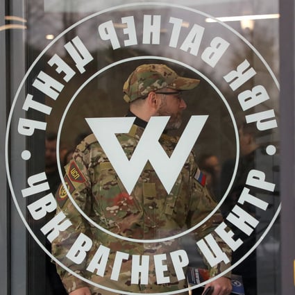 A man wearing a camouflage uniform walks out of the PMC Wagner Centre, a project implemented by the businessman and founder of the Wagner private military group Yevgeny Prigozhin, during the official opening of the office block in St Petersburg, Russia in November. Photo: Reuters
