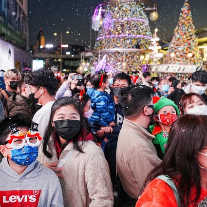 Hong Kong residents gather in Tsim Sha Tsui, where the promenade has been decorated with Christmas lights. Photo: Reuters 