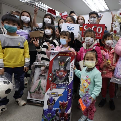Underprivileged children with some of the Christmas gifts they received this year. Photo: Yik Yeung-man