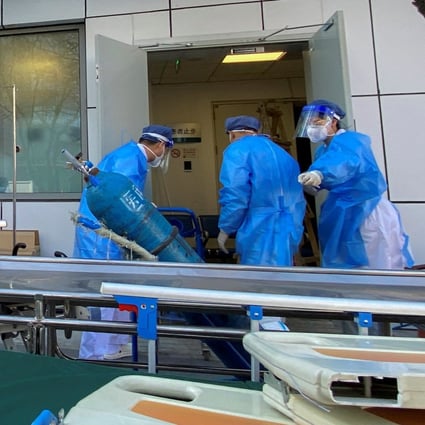 Medical workers are seen outside a fever clinic at a hospital in Beijing on Friday as the city battles a wave of cases. Photo: Reuters