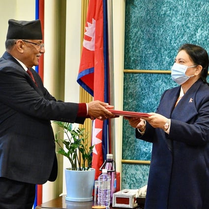 Nepal’s former guerrilla leader Pushpa Kamal Dahal (left), better known by his nom de guerre Prachanda, hands over his documents to President Bidya Devi Bhandari to claim majority for his appointment as the new prime minister, at the president’s office in Kathmandu on December 25, 2022. Photo: AFP