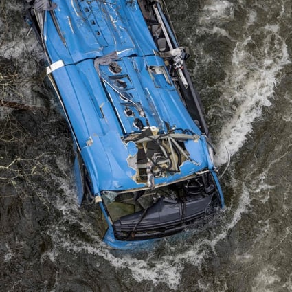 The wreck of a bus lies in the Lerez river in Spain after it plunged in while crossing a bridge on Sunday. Photo: AFP