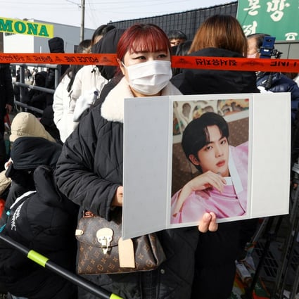 Fans wait for the arrival of Jin, of the K-pop band BTS, outside a South Korean army boot camp in Yeoncheon, South Korea on December 13, the day he enlisted to do his military service. Jin sent a message on Weverse, the app for K-pop fans, that day. Photo: Reuters