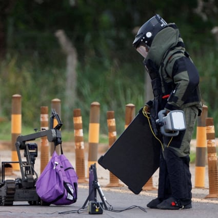 Anti-bomb officers work to defuse what is believed to be an explosive device in Brasilia, Brazil on Saturday. Photo: Reuters