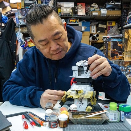 Manson Ng at his store and workshop in Hong Kong’s Mong Kok district, where he builds Gundam models, or “Gunpla”, for a living – and for a hobby. Now 53, Ng was the over-21s champion of this year’s Gunpla Builders World Cup. Photo: Sam Li