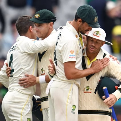 Mitchell Starc (centre) and David Warner of Australia celebrate their victory over South Africa at the MCG. Photo: EPA-EFE