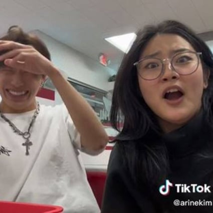 Arine Kim (right) and her male friend react to racist and homophobic comments directed at them by a man at an In-N-Out Burger restaurant. Photo: TikTok