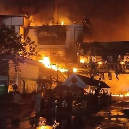 Firefighters battle a blaze at the Grand Diamond City hotel-casino in Poipet, Cambodia, on Thursday. Photo: AFP