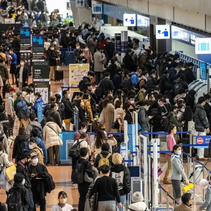 Travellers at Tokyo’s Haneda airport. Photo: AFP