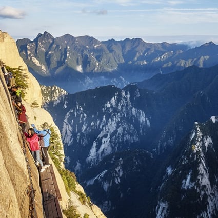 Tourists take on the “plank walk”, among the world’s most dangerous trails. Photo: Shutterstock Images