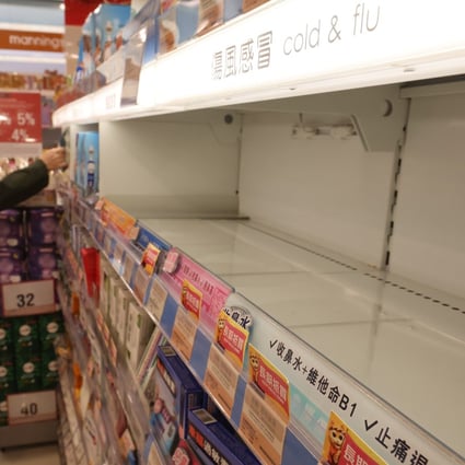 A shelf empty of painkillers and cold and flu medicine in a Kowloon Bay shop on December 27. Some Hongkongers have been snapping up fever and pain-relief drugs for their relatives and friends over the border, which has caused shortages at some pharmacies. Photo: Edmond So