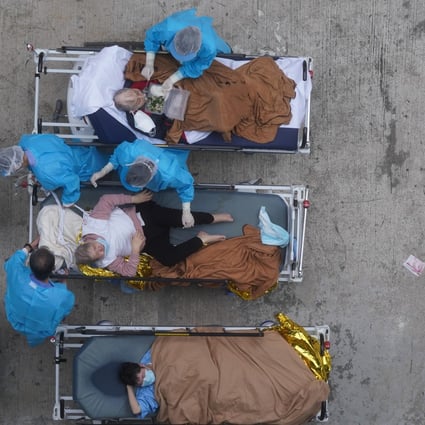 Medical staff treat Covid-19 patients at a temporary holding area outside Caritas Medical Centre during the height of the fifth wave. Photo: Sam Tsang