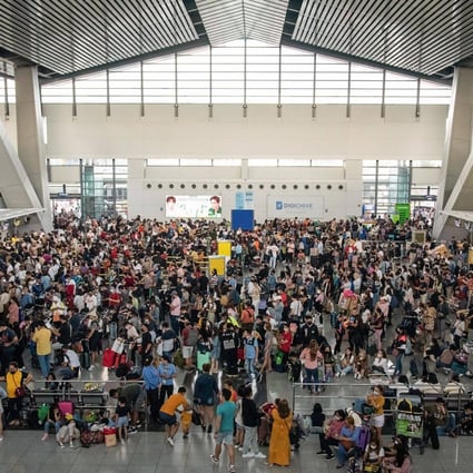 Stranded passengers wait for information about their flights at terminal 3 of Ninoy International Airport in Pasay, Metro Manila on Sunday. Photo: AFP