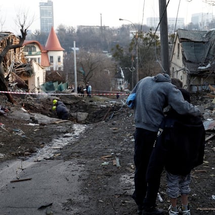 A local resident embraces his son as they stand next to a site of a Russian missile strike, amid Russia’s attack on Ukraine, in Kyiv, Ukraine on December 31, 2022.Photo: Reuters/File
