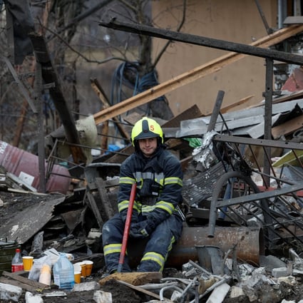 A rescuer rests at a site of a residential house damaged during Russia’s attack on Kyiv, Ukraine, on December 29. Photo: Reuters
