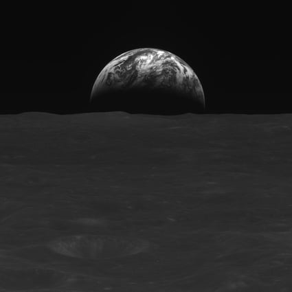 A black-and-white image of the Moon’s surface and Earth taken by South Korean lunar orbiter Danuri. Photo: Handout via AFP