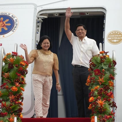 Philippine President Ferdinand Marcos Jnr (right) and his wife Marie Louise wave as they board a plane for China on Tuesday at the Villamor Air Base in Manila. Photo: AP