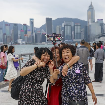 Tourists share a light moment at the Avenue of Stars on the Tsim Sha Tsui promenade in Hong Kong during the mini-golden week holiday on the mainland on May 2, 2019. Photo: Sam Tsang