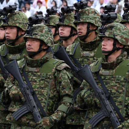Japanese soldiers take part in a military review in Asaka. Tokyo last month announced its biggest defence overhaul in decades, increasing spending, reshaping its military command and acquiring new missiles. Photo: AFP