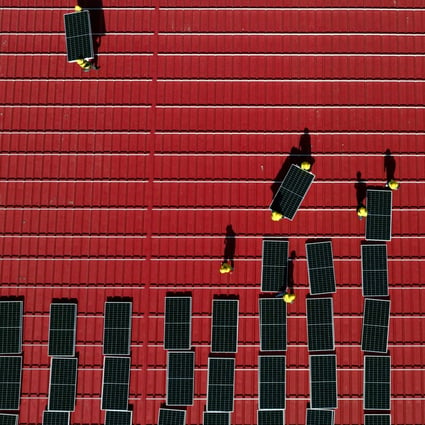 Workers install solar power panels on the roof of a factory in Tangshan, north China’s Hebei province. Chinese firms are seen benefiting from a financing pact for Vietnam. Photo: Xinhua
