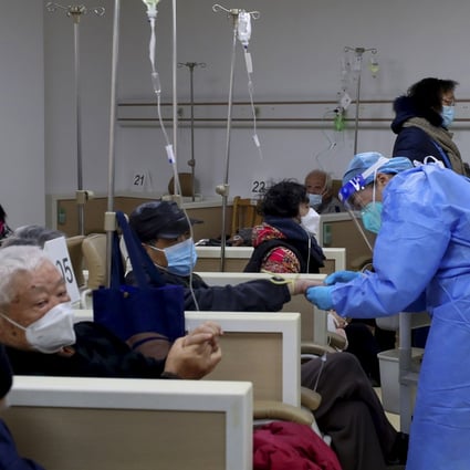 A medical worker helps a patient with an intravenous drip at a community healthcare centre in Shanghai as Covid-19 rips through China. Photo: Xinhua via AP