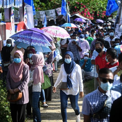 People queue outside a polling station to cast their vote during the 2020 Sabah state election. File photo: BERNAMA/dpa