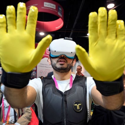 An attendee uses tactile gloves and vest during a VR demonstration at the bHaptics booth during CES 2023 at the Las Vegas Convention Center on January 6. Photo: Getty Images via AFP