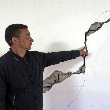A resident of Joshimath, India’s Uttarakhand state, points to a crack in the wall of his house on Sunday. Photo: AFP