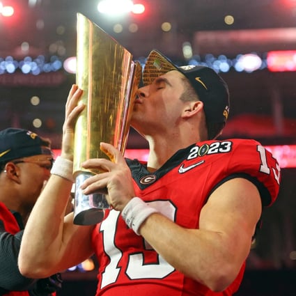 Georgia quarterback Stetson Bennett kisses the trophy after winning the CFP national championship game TCU. Photo: USA TODAY Sports