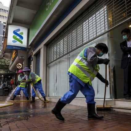 Workers cleaning at Standard Chartered’s Chung On Street branch in Tsuen Wan in March 2020. Photo: Winson Wong